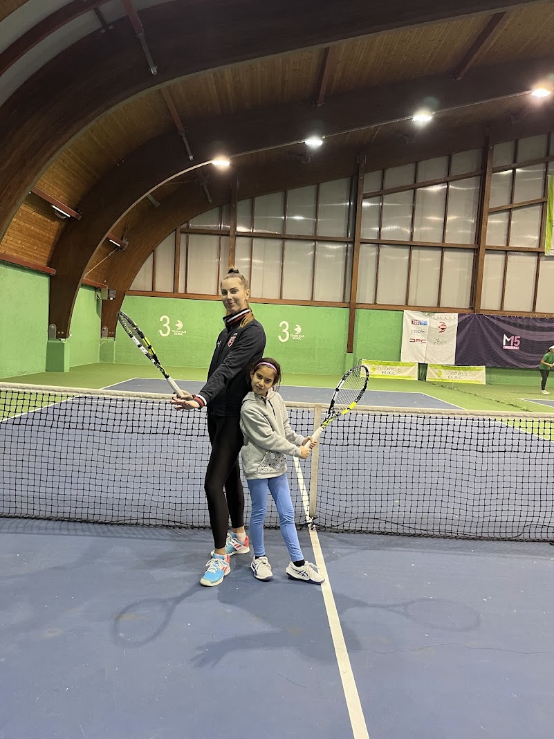 Junior tennis development - Coach Tamara with young player at tennis facility